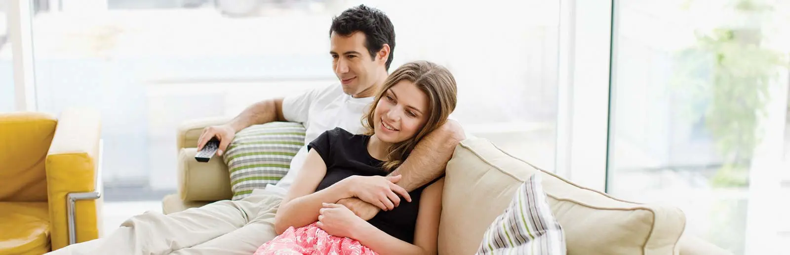 Couple on couch with peace of mind because they have registered their Ducane product