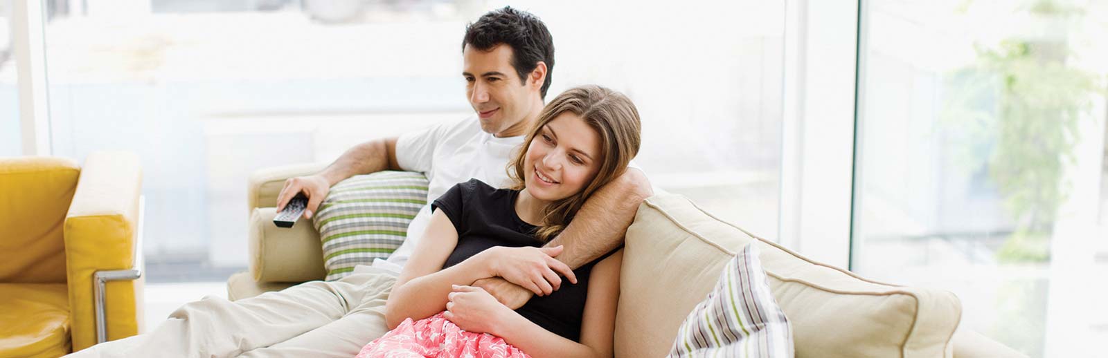 Couple on couch with peace of mind because they have registered their Ducane product