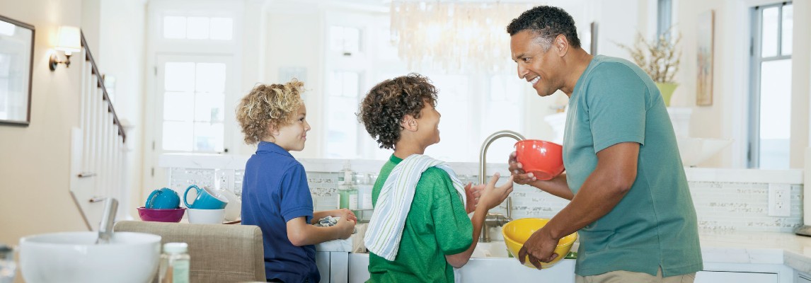 Kids and Father Standing in Bright Kitchen